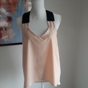 Women's racerback top with faux leather straps.